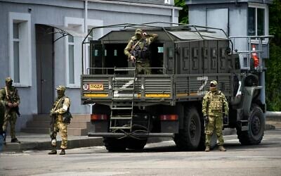 Illustrative: Russian soldiers guard an area as a group of foreign journalists visit Kherson during the occupation, Kherson region, south Ukraine, on May 20, 2022. (AP Photo)