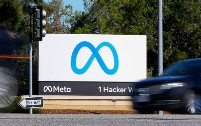 A car passes Facebook's new Meta logo on a sign at the company headquarters in Menlo Park, California, on October 28, 2021. (Tony Avelar/AP)