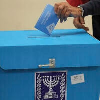 A voter casts a ballot during Israel's fifth election in less than four years at a polling station in the coastal city of Tel Aviv, Nov. 1, 2022 (Jack Guez/Pool Photo via AP)