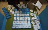 Electoral official arrange ballots in the West Bank settlement of Kiryat Arba during Israeli elections, Tuesday, Nov. 1, 2022. (AP Photo/Tsafrir Abayov)