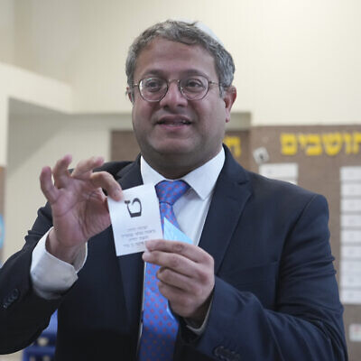 Israeli far-right lawmaker Itamar Ben Gvir shows his ballot in the West Bank settlement of Kiryat Arba during Israeli elections, November 1, 2022. (AP Photo/Tsafrir Abayov)