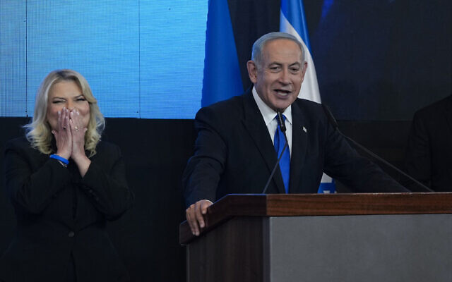 Likud leader Benjamin Netanyahu addresses supporters at the party's campaign headquarters in Jerusalem early on November 2, 2022, with his wife Sara at his side. (AP Photo/Tsafrir Abayov) Likud leader Benjamin Netanyahu addresses supporters at the party's campaign headquarters in Jerusalem early on November 2, 2022, with his wife Sara at his side. (AP Photo/Tsafrir Abayov)