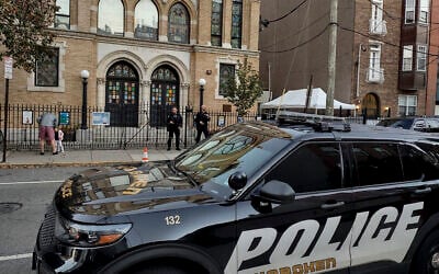 Police officers stand watch outside the United Synagogue of Hoboken, New Jersey, Thursday, November 3, 2022, after the FBI warned of a 'broad threat' to Jewish places of worship in the state. (AP/Ryan Kryska)