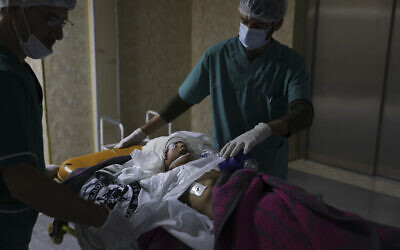 Doctors treat a child wounded in shelling at a hospital in the town of Idlib, Syria, Nov. 6, 2022. (AP Photo/Ghaith Alsayed)