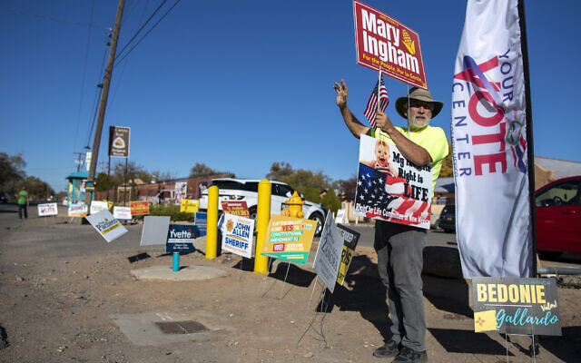 Stewart Ingham waves to motorists while campaigning for his wife Mary Ingham, a candidate for the New Mexico State House of Representatives, outside a polling center in the South Valley area of Albuquerque, N.M., Tuesday, Nov. 8, 2022 (AP/Andres Leighton) Stewart Ingham waves to motorists while campaigning for his wife Mary Ingham, a candidate for the New Mexico State House of Representatives, outside a polling center in the South Valley area of Albuquerque, N.M., Tuesday, Nov. 8, 2022 (AP/Andres Leighton)