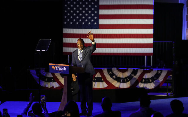 Democratic nominee for US Senate Senator Raphael Warnock waves to supporters after speaking during an election-night watch party, November 9, 2022 in Atlanta. (AP Photo/John Bazemore) Democratic nominee for US Senate Senator Raphael Warnock waves to supporters after speaking during an election-night watch party, November 9, 2022 in Atlanta. (AP Photo/John Bazemore)