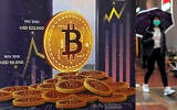 An advertisement for Bitcoin cryptocurrency is displayed on a street in Hong Kong, on Feb. 17, 2022. (AP/Kin Cheung)