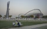 A migrant worker sleeps on a bench before his early morning shift, in front of Khalifa International Stadium, which will host matches during FIFA World Cup 2022, in Doha, Qatar, Oct. 15, 2022. (AP Photo/Nariman El-Mofty, File)