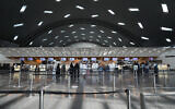 Passengers walk at Hamad International Airport in Doha, Qatar, November 10, 2022. (AP Photo/Hassan Ammar)