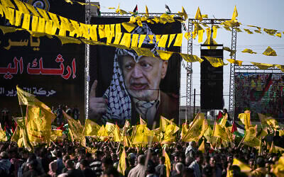 Palestinians chant slogans and wave yellow Fatah movement flags during a rally marking the 18th anniversary of the death of Fatah founder and Palestinian Authority leader Yasser Arafat in Gaza City, Thursday, Nov. 10, 2022. (AP Photo/Fatima Shbair)