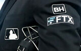 The FTX logo appears on a jacket at a baseball game with the Minnesota Twins on Tuesday, Sept. 27, 2022, in Minneapolis. (AP/Bruce Kluckhohn)