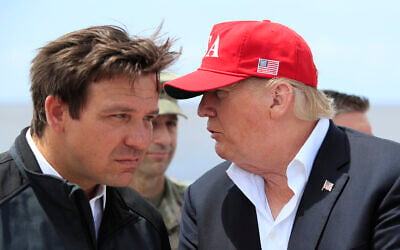 File: US President Donald Trump talks to Florida Governor Ron DeSantis, left, during a visit to Lake Okeechobee and Herbert Hoover Dike at Canal Point, Florida, March 29, 2019. (AP Photo/Manuel Balce Ceneta, File) File: US President Donald Trump talks to Florida Governor Ron DeSantis, left, during a visit to Lake Okeechobee and Herbert Hoover Dike at Canal Point, Florida, March 29, 2019. (AP Photo/Manuel Balce Ceneta, File)