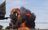 A historic US military plane crashes after colliding with another plane during an airshow at Dallas Executive Airport in Dallas on November 12, 2022. (Nathaniel Ross Photography via AP)