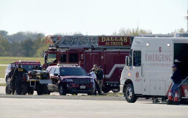 Emergency responders on the flightline at the Dallas Executive Airport where two vintage US aircraft crashed during an airshow, November 12, 2022. (AP Photo/LM Otero)