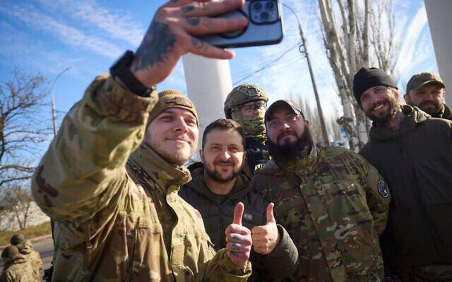 In this photo provided by the Ukrainian Presidential Press Office and posted on Facebook, Ukrainian soldiers take a selfie with President Volodymyr Zelensky, centre, during his visit to Kherson, Ukraine, Monday, Nov. 14, 2022. (Ukrainian Presidential Press Office via AP) In this photo provided by the Ukrainian Presidential Press Office and posted on Facebook, Ukrainian soldiers take a selfie with President Volodymyr Zelensky, centre, during his visit to Kherson, Ukraine, Monday, Nov. 14, 2022. (Ukrainian Presidential Press Office via AP)
