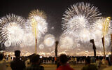 Fans watch fireworks after the World Cup inauguration match between Qatar and Ecuador at the Corniche sea promenade in Doha, Qatar, November 20, 2022. (AP/Francisco Seco)