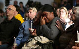 Tyrice Kelley, center right, a performer at Club Q, is comforted during a service held at All Souls Unitarian Church following an overnight fatal shooting at the gay nightclub, in Colorado Springs, Colo., on Sunday, Nov. 20, 2022. (Parker Seibold/The Gazette via AP)