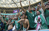 Saudi Arabia's fans celebrate their victory after the World Cup group C soccer match between Argentina and Saudi Arabia at the Lusail Stadium in Lusail, Qatar, November 22, 2022. (AP Photo/Jorge Saenz)