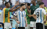 Argentina's Lionel Messi standing beside Saudi Arabia's players celebrating after winning the World Cup group C soccer match between Argentina and Saudi Arabia at the Lusail Stadium in Lusail, Qatar, November 22, 2022. (AP Photo/Natacha Pisarenko)