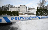 A police tape cordons an area outside a house where Swedish Security Service allegedly arrested two people on suspicions of espionage in a predawn operation in Stockholm, November 22 2022. (Fredrik Sandberg/TT News Agency via AP)
