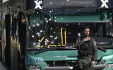 Israeli police inspect the scene of a terrorist bombing at a bus stop in Jerusalem, November 23, 2022. (AP Photo/Mahmoud Illean)