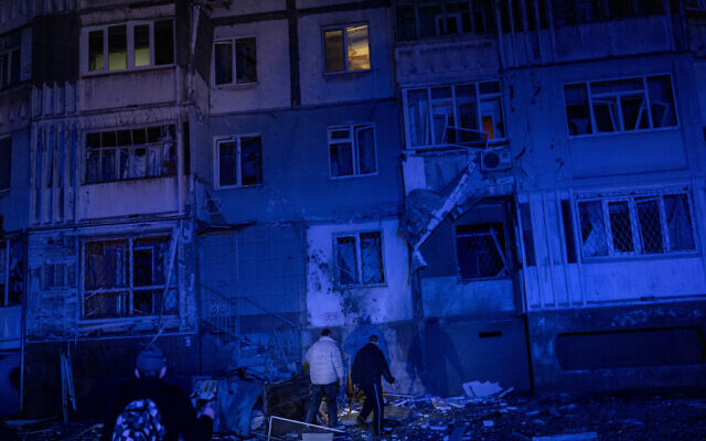 Resident walk amid debris after a Russian attack in Kherson, southern Ukraine, Thursday, Nov. 24, 2022. (AP Photo/Bernat Armangue) Resident walk amid debris after a Russian attack in Kherson, southern Ukraine, Thursday, Nov. 24, 2022. (AP Photo/Bernat Armangue)