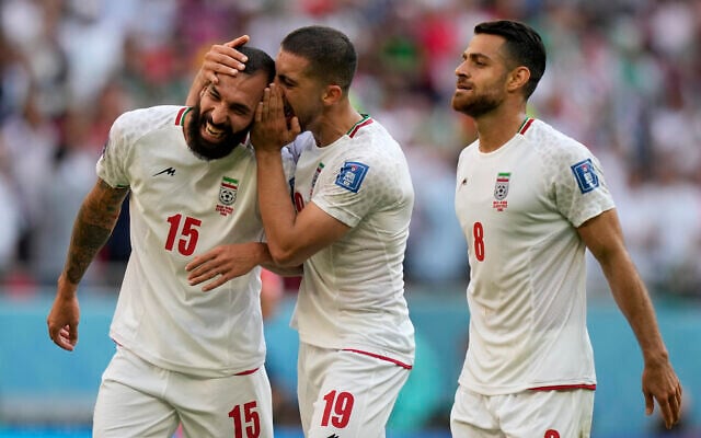 Iran's Majid Hosseini, from right, Iran's Morteza Pouraliganji and Iran's scorer Rouzbeh Cheshmihe celebrate after winning the World Cup group B soccer match between Wales and Iran, at the Ahmad Bin Ali Stadium in Al Rayyan, Qatar, November 25, 2022. (AP/Frank Augstein) Iran's Majid Hosseini, from right, Iran's Morteza Pouraliganji and Iran's scorer Rouzbeh Cheshmihe celebrate after winning the World Cup group B soccer match between Wales and Iran, at the Ahmad Bin Ali Stadium in Al Rayyan, Qatar, November 25, 2022. (AP/Frank Augstein)