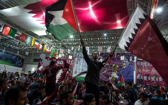 Palestinian soccer fans wave Qatari and Palestinian flags as they watch a live broadcast of the 2022 World Cup opening match between Qatar and Ecuador, at a covered gymnasium in Gaza City, on Nov. 20, 2022. (AP Photo/Fatima Shbair, File) Palestinian soccer fans wave Qatari and Palestinian flags as they watch a live broadcast of the 2022 World Cup opening match between Qatar and Ecuador, at a covered gymnasium in Gaza City, on Nov. 20, 2022. (AP Photo/Fatima Shbair, File)