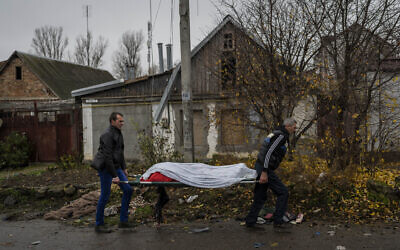 City workers collect the body of a man in Kherson, southern Ukraine, Friday, Nov. 25, 2022. The man died during a Russian attack the day before. (AP/Bernat Armangue) City workers collect the body of a man in Kherson, southern Ukraine, Friday, Nov. 25, 2022. The man died during a Russian attack the day before. (AP/Bernat Armangue)