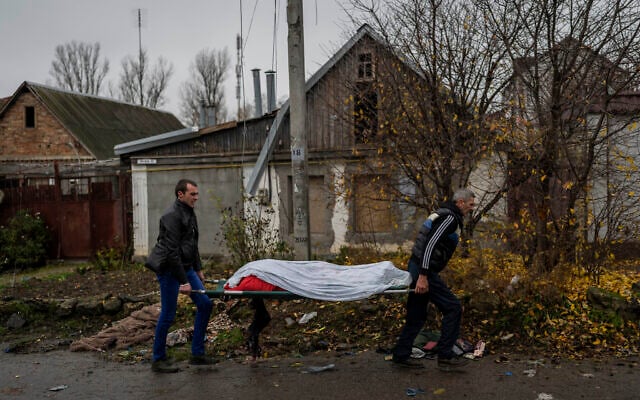City workers collect the body of a man in Kherson, southern Ukraine, Friday, Nov. 25, 2022. The man died during a Russian attack the day before. (AP/Bernat Armangue) City workers collect the body of a man in Kherson, southern Ukraine, Friday, Nov. 25, 2022. The man died during a Russian attack the day before. (AP/Bernat Armangue)