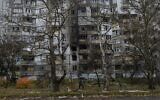 A woman walks past a recently damaged building due to a Russian strike on the recently-liberated Kherson, southern Ukraine, November 25, 2022. (AP Photo/Bernat Armangue)