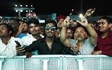 Migrant workers cheer at a fan festival at the Asian Town cricket stadium in Doha, Qatar, November 25, 2022. (AP/Jon Gambrell)