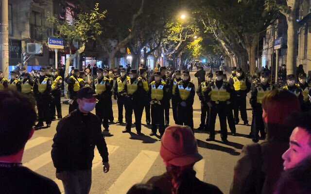 Chinese police officers block off access to a site where protesters had gathered in Shanghai on November 27, 2022. (AP Photo) Chinese police officers block off access to a site where protesters had gathered in Shanghai on November 27, 2022. (AP Photo)
