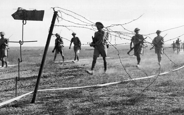 Infantrymen of the British Eighth Army advance through a gap in Nazi minefield in front of the Mareth Line in Tunisia  on March 25, 1943. (AP Photo/British Official Photo)