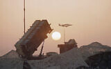 Illustrative: A pair of F-16 fighter jets streak past a Patriot Missile Defense Battery as the sun sets, at an airbase in Saudi Arabia, October 8, 1990. (John Gaps/AP)