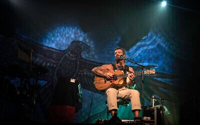 Australian indie rocker Xavier Rudd played Tel Aviv on November 12, 2022, in a rousing solo show at Hangar 11, beneath a massive cloth backdrop depicting a Bunjil totem. Bunjil was an Aboriginal mythical leader often depicted as an eagle, who is believed to be the protector of the natural world, his people and their beliefs. (courtesy, Dawid Rygielski Photography)