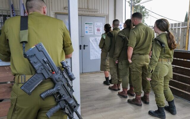 IDF soldiers cast their votes in a ballot box of the Golan Brigade 474 for Israel's general election at the Sa'ar military base in central Golan Heights on November 1, 2022. (Michael Giladi/Flash90)