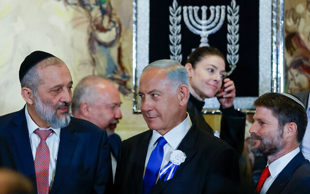 Likud leader MK Benjamin Netanyahu, center, with Shas leader MK Aryeh Deri, left, and Religious Zionism head MK Bezalel Smotrich at a swearing-in ceremony of the 25th Knesset, at the Israeli parliament in Jerusalem, November 15, 2022.(Olivier Fitoussi/Flash90) Likud leader MK Benjamin Netanyahu, center, with Shas leader MK Aryeh Deri, left, and Religious Zionism head MK Bezalel Smotrich at a swearing-in ceremony of the 25th Knesset, at the Israeli parliament in Jerusalem, November 15, 2022.(Olivier Fitoussi/Flash90)