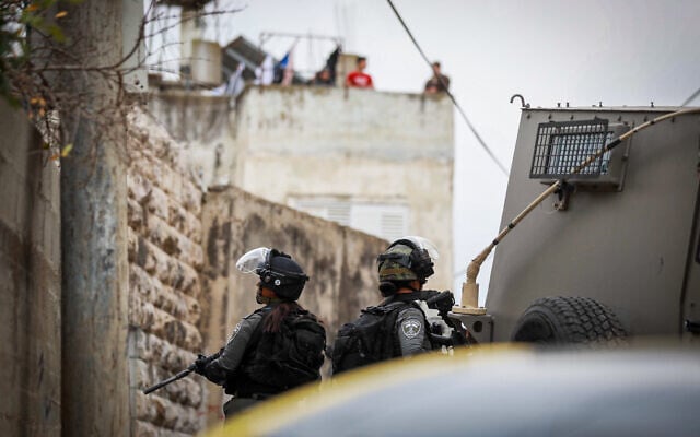 Israeli forces seen during a raid in the village of Hares in the West Bank, following a terror attack outside Ariel, in the West Bank, on November 15, 2022. (Flash90) Israeli forces seen during a raid in the village of Hares in the West Bank, following a terror attack outside Ariel, in the West Bank, on November 15, 2022. (Flash90)