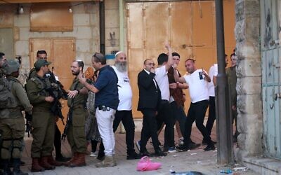 Illustrative: Jews tour in the West Bank city of Hebron, after earlier clashes broke out between Jews and Palestinians, November 19, 2022. (Wisam Hashlamoun/Flash90)