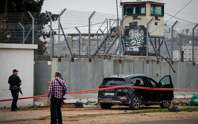 Security forces near a vehicle of a Palestinian man who carried out a ramming attack near the West Bank outpost of Migron, on November 29, 2022. (Olivier Fitoussi/Flash90)