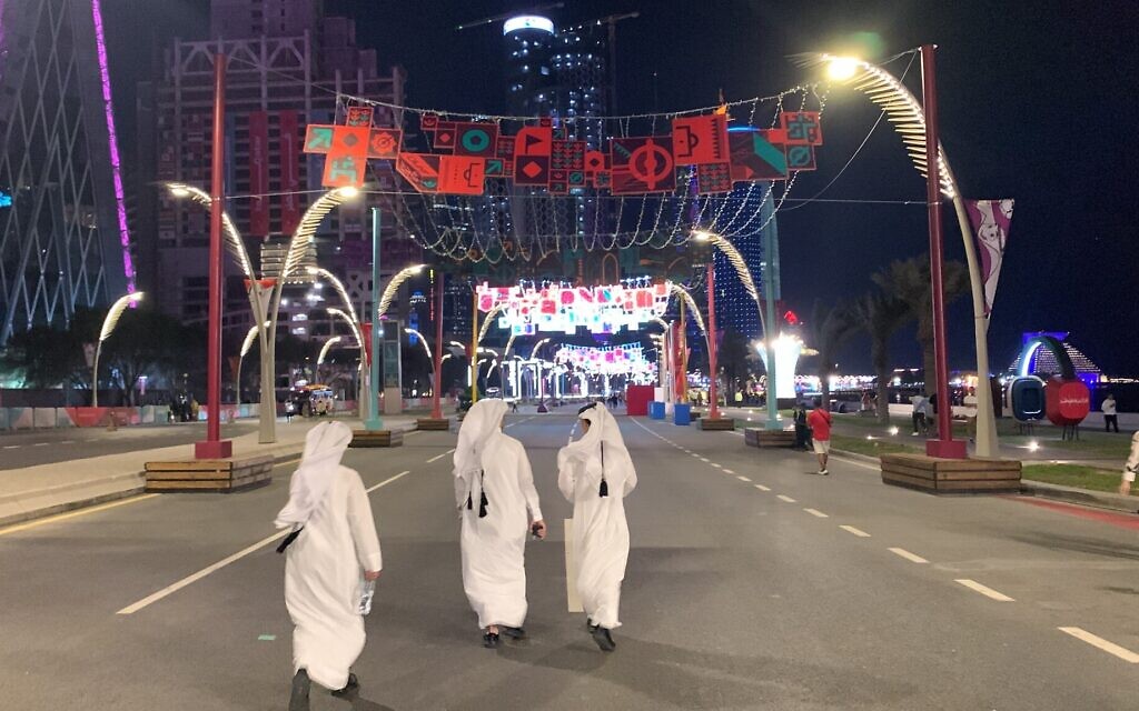 Qatari locals walk down Doha's Corniche Street following their country's opening-match loss to Ecuador, November 20, 2022. (Ash Obel/Times of Israel) Qatari locals walk down Doha's Corniche Street following their country's opening-match loss to Ecuador, November 20, 2022. (Ash Obel/Times of Israel)