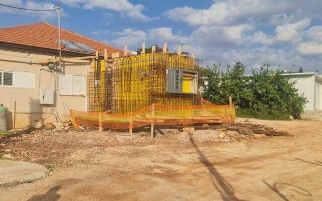 Defense Ministry and military engineers work to construct bomb shelters in homes in the northern town of Avivim, November 22, 2022. (Defense Ministry)