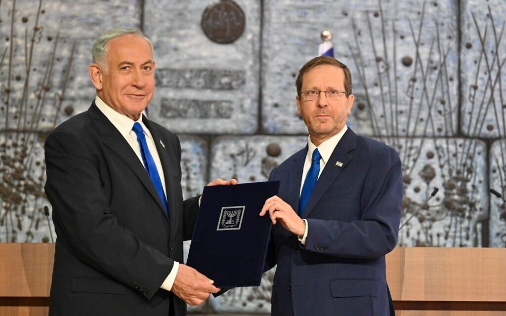 Likud leader Benjamin Netanyahu (L) and President Isaac Herzog at the President's Residence in Jerusalem, as Herzog tasks Netanyahu with forming a governing coalition, November 13, 2022. (Kobi Gideon/GPO)