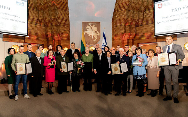 Yad Vashem chairman Dani Dayan, center-right, stands with the descendants of four Lithuanian families who were recognized as being 'Righteous among the Nations' for saving Jews during the Holocaust, at a ceremony in Vilnius, Lithuania, on November 7, 2022. (Yad Vashem) Yad Vashem chairman Dani Dayan, center-right, stands with the descendants of four Lithuanian families who were recognized as being 'Righteous among the Nations' for saving Jews during the Holocaust, at a ceremony in Vilnius, Lithuania, on November 7, 2022. (Yad Vashem)