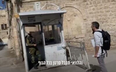 A screenshot from a video of an IDF soldier cursing an activist from the left-wing Breaking the Silence group at a checkpoint in the West Bank City of Hebron, November 16, 2022. (Twitter screenshot: used in accordance with Clause 27a of the Copyright Law)