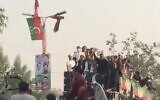 Screen capture from video showing former Pakistan prime minister Imran Khan, center-right waving, a moment before shots were fired at his vehicle, injuring him the leg, November 3, 2022. (Twitter. Used in accordance with Clause 27a of the Copyright Law)