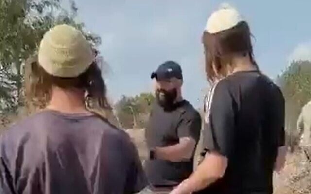Settler youth seen confronting a Palestinian farmer in a Palestinian-owned olive grove in the West Bank, as farmers said they found dozens of trees cut down in Turmus Ayya, near Ramallah, November 7, 2022. (Video screenshot) Settler youth seen confronting a Palestinian farmer in a Palestinian-owned olive grove in the West Bank, as farmers said they found dozens of trees cut down in Turmus Ayya, near Ramallah, November 7, 2022. (Video screenshot)