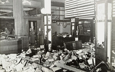 German Nazis stand by ransacked Jewish property during Kristallnacht, most likely in the town of Fuerth, Germany, on Nov. 10, 1938. (Yad Vashem via AP)