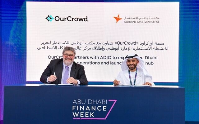 OurCrowd founder and CEO Jon Medved, left, signs an agreement to expand the company in the UAE with support from the Abu Dhabi Investment Office, November 2022. Acting director-general of ADIO, Abdulla Abdul Aziz AlShamsi, also signed the agreement. (Courtesy / OurCrowd) OurCrowd founder and CEO Jon Medved, left, signs an agreement to expand the company in the UAE with support from the Abu Dhabi Investment Office, November 2022. Acting director-general of ADIO, Abdulla Abdul Aziz AlShamsi, also signed the agreement. (Courtesy / OurCrowd)